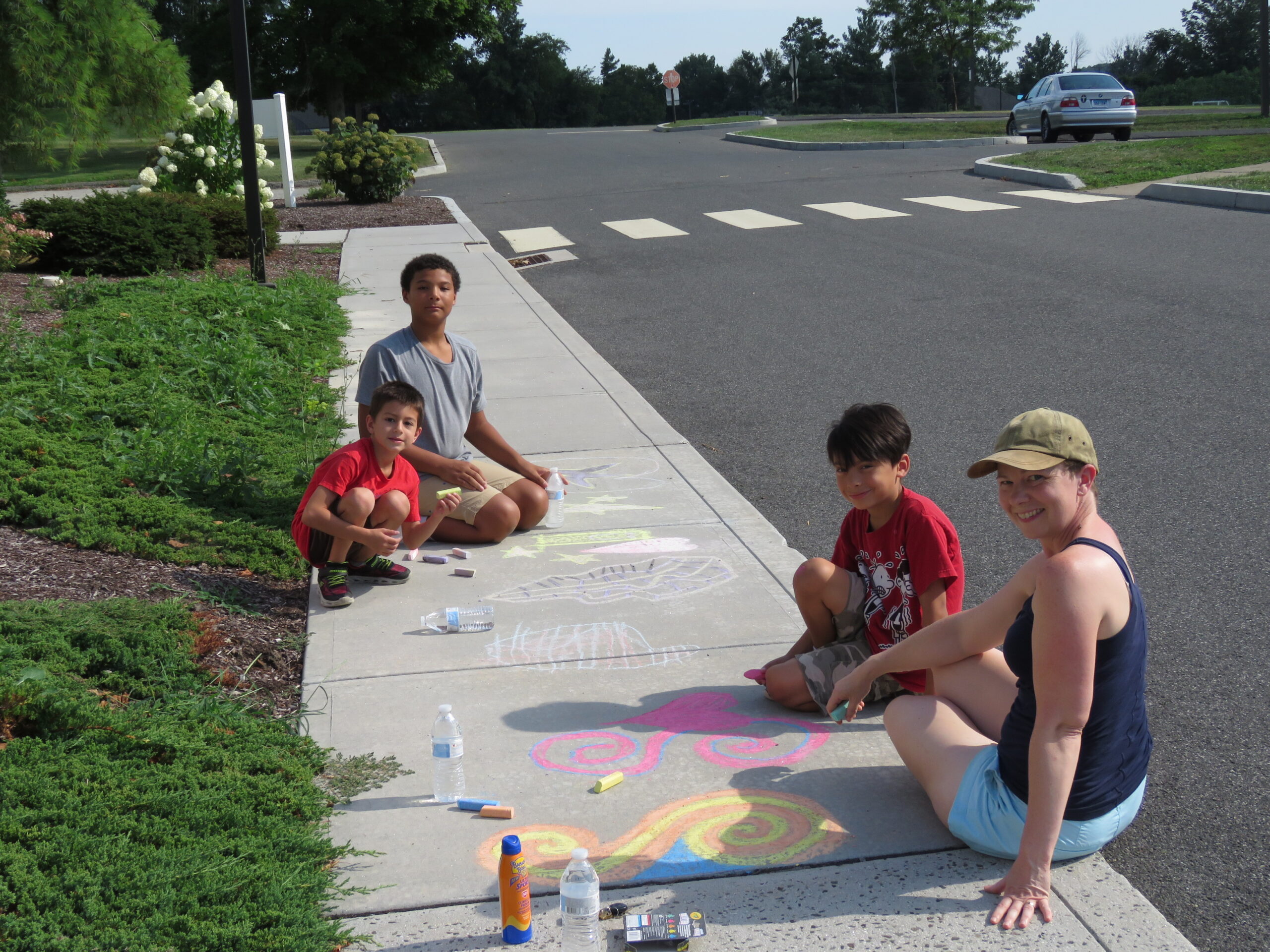 A Brookfield family participating in the Brookfield Creates...Sidewalk Chalk event outside Town Hall.