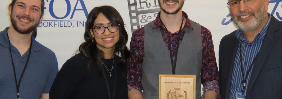 Duino filmmaker holding the award for Best Short Film at the 1st Regional Indie Afternoon.