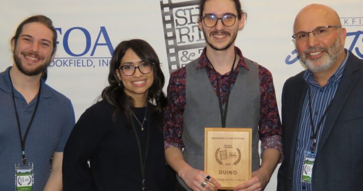 Duino filmmaker holding the award for Best Short Film at the 1st Regional Indie Afternoon.